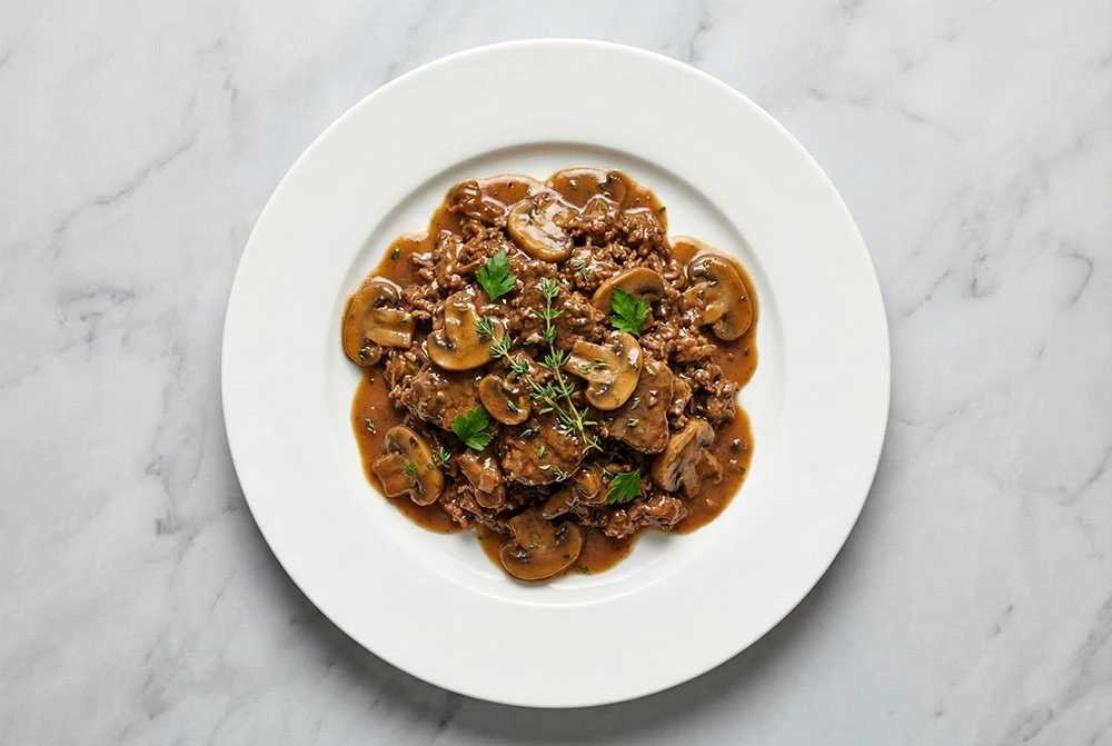 Rich, deeply flavored ground beef, braised to perfection with a velvety mushroom gravy. Elevates weeknight comfort food.